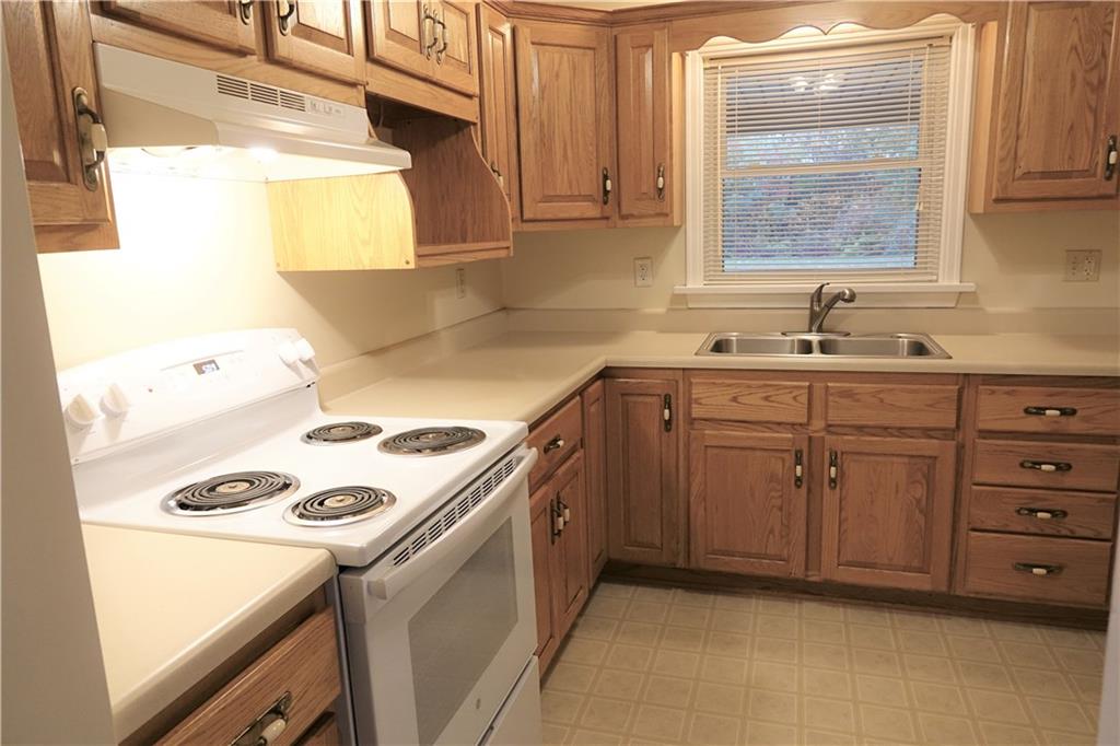 504 Chicora Road Butler, PA 16001 - Photo 7 of 24 Kitchen with custom oak cabinetry, abundant countertop space. Stove and refrigerator included.