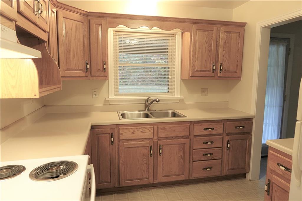 504 Chicora Road Butler, PA 16001 - Photo 8 of 24 Kitchen with custom oak cabinetry and abundant countertop space. Stove and refrigerator included.