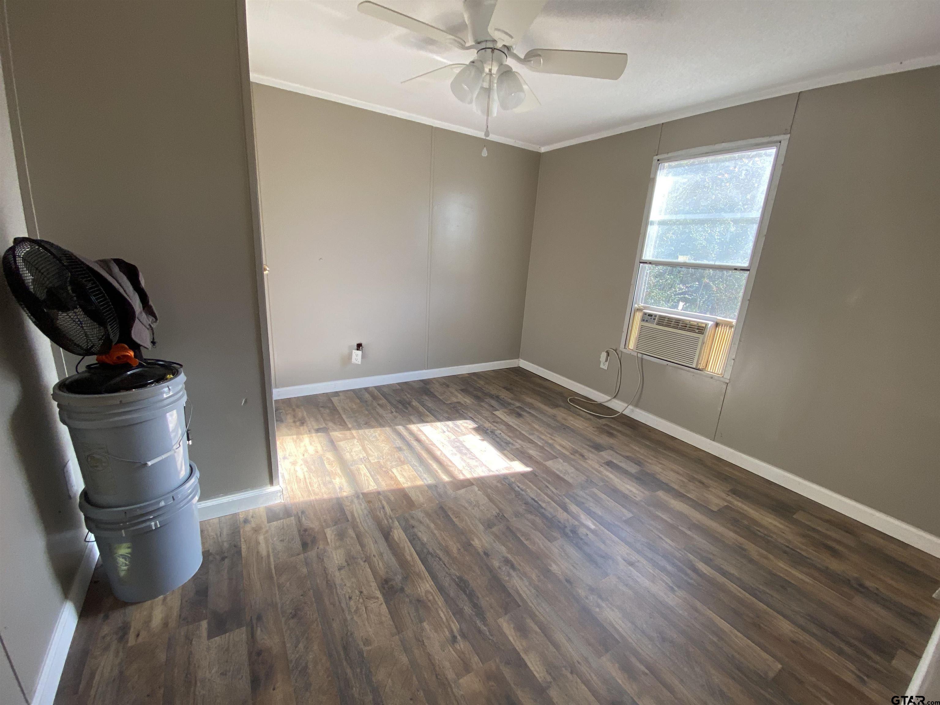 7761 Fm 1251 Henderson, TX 75652 - Photo 11 of 29 wooden floor in an empty room with a window