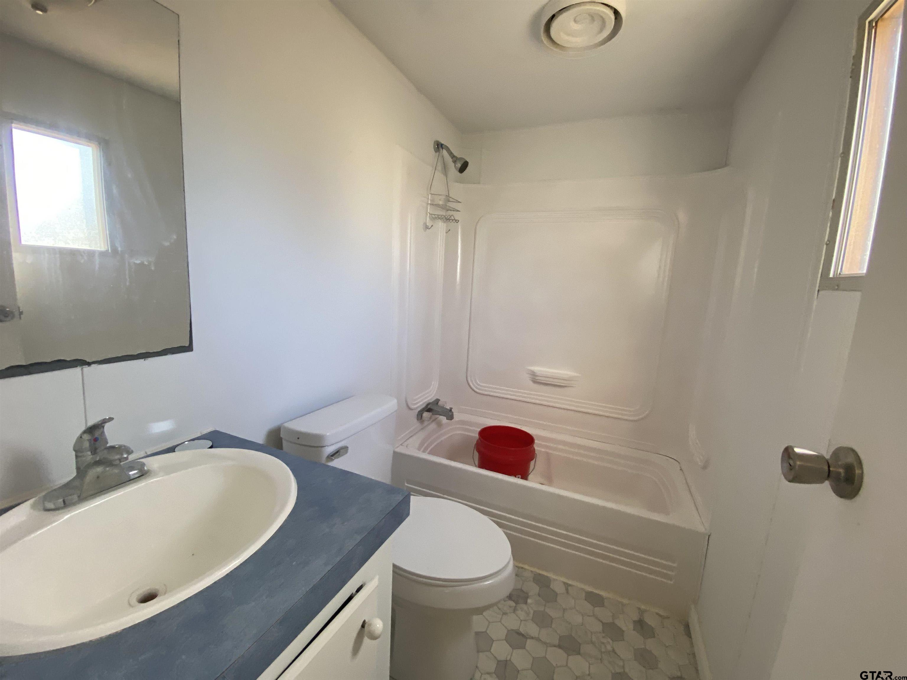 7761 Fm 1251 Henderson, TX 75652 - Photo 12 of 29 a bathroom with a sink toilet and shower