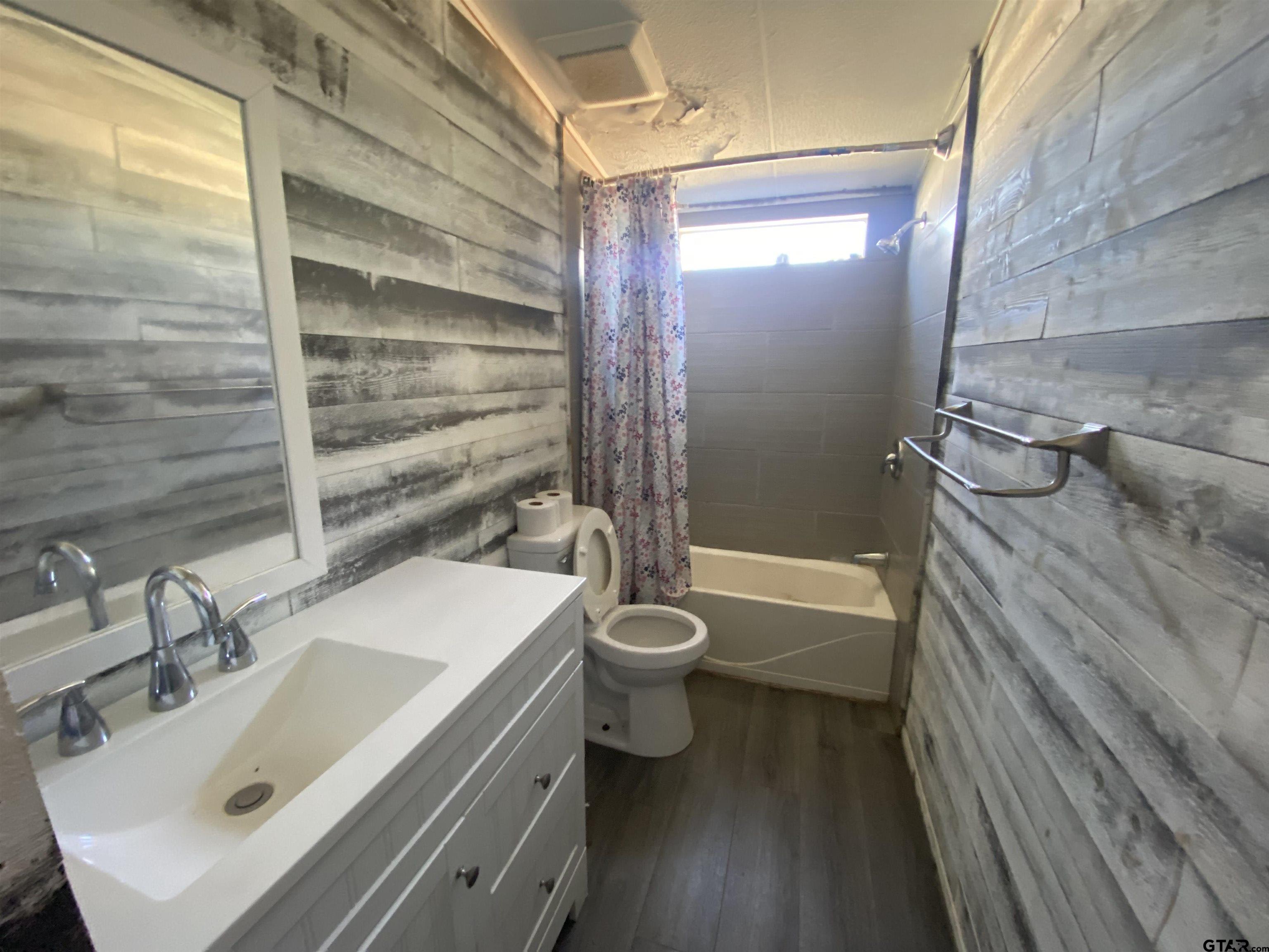 7761 Fm 1251 Henderson, TX 75652 - Photo 15 of 29 a bathroom with a sink a toilet and shower