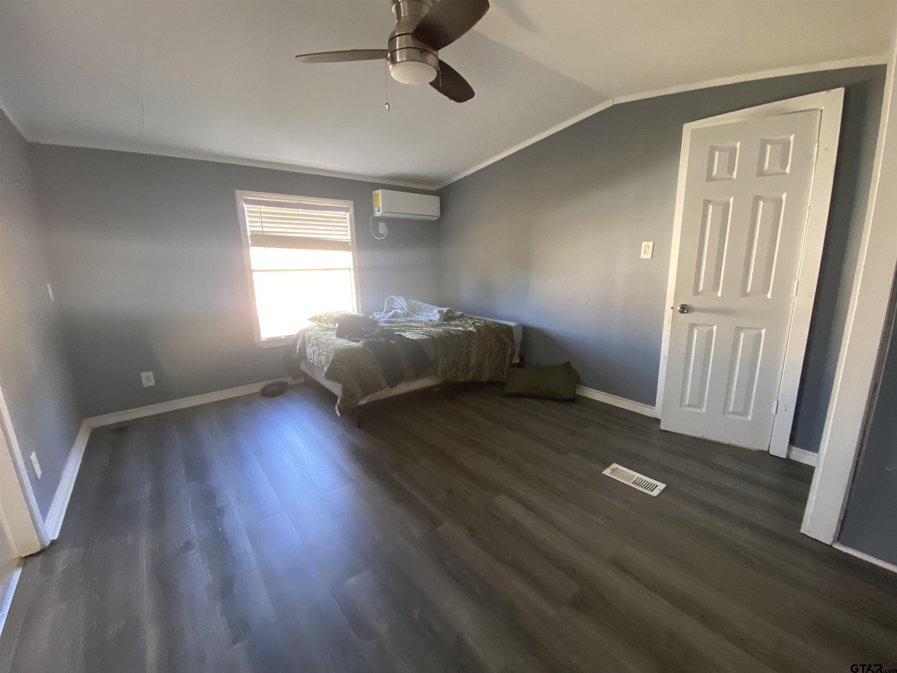 7761 Fm 1251 Henderson, TX 75652 - Photo 20 of 29 wooden floor in an empty room with a window