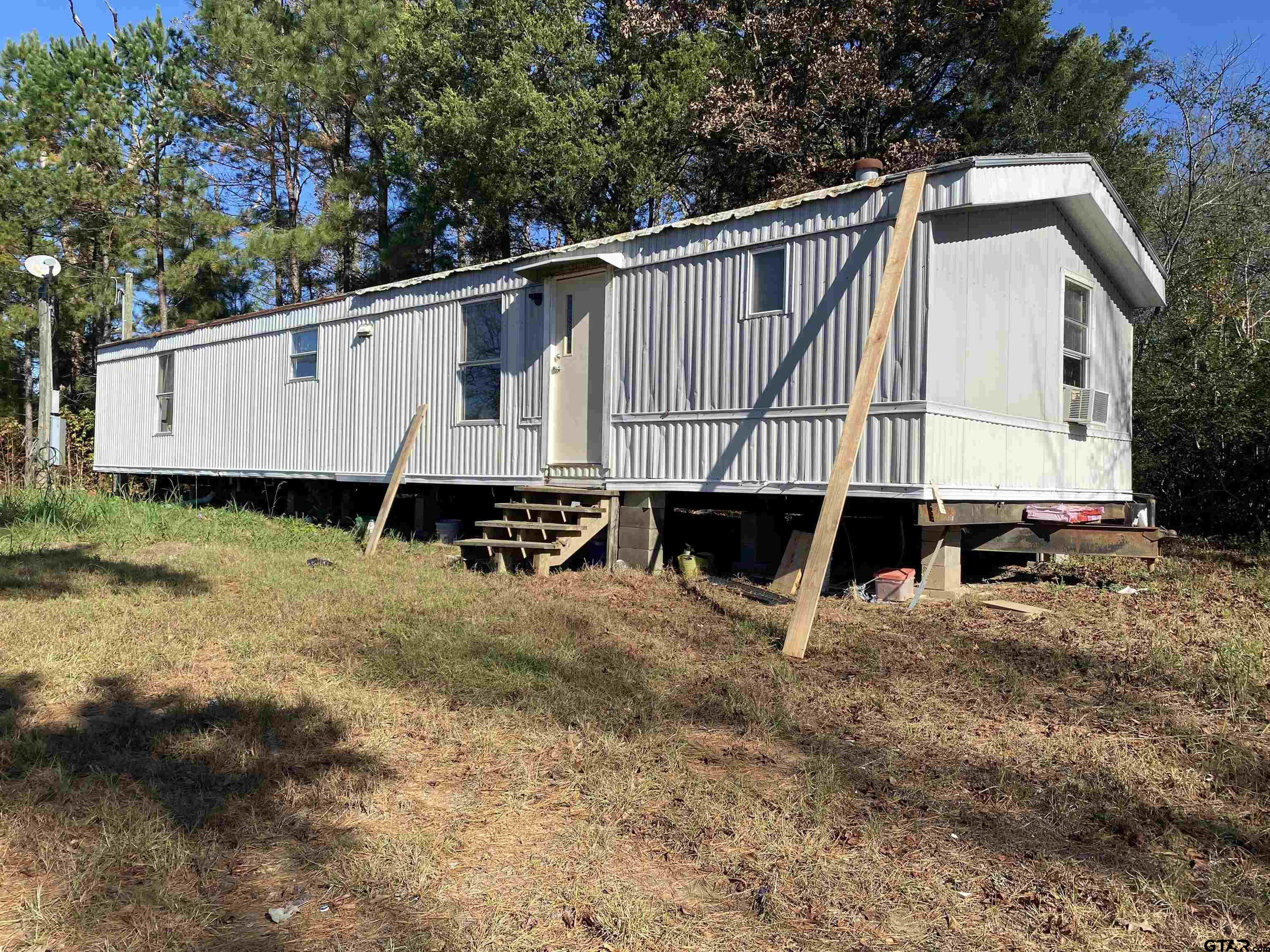 7761 Fm 1251 Henderson, TX 75652 - Photo 2 of 29 a view of a house with backyard