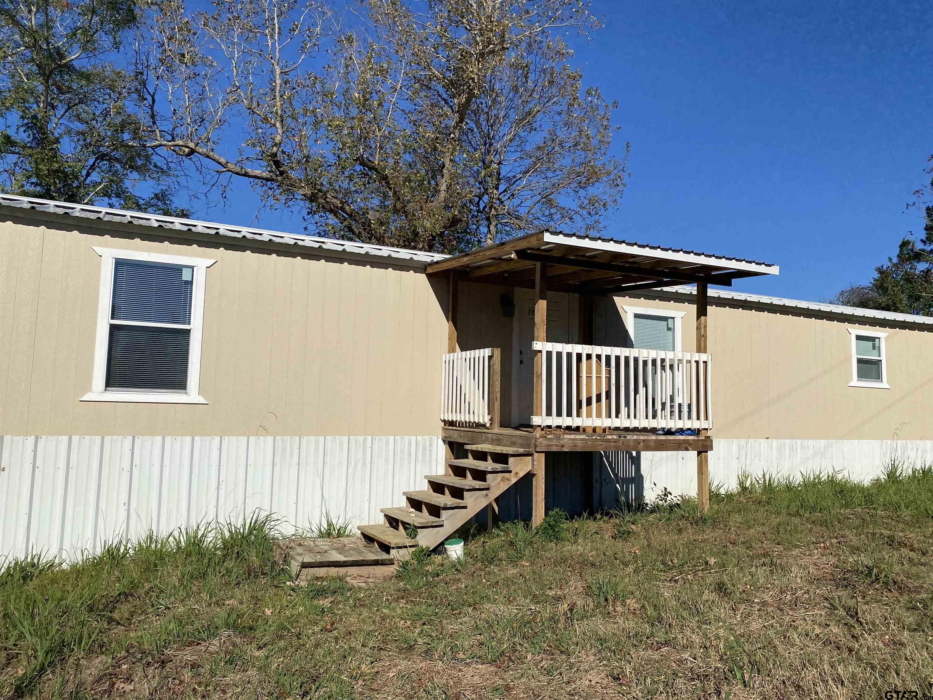 7761 Fm 1251 Henderson, TX 75652 - Photo 23 of 29 a front view of a house with a yard