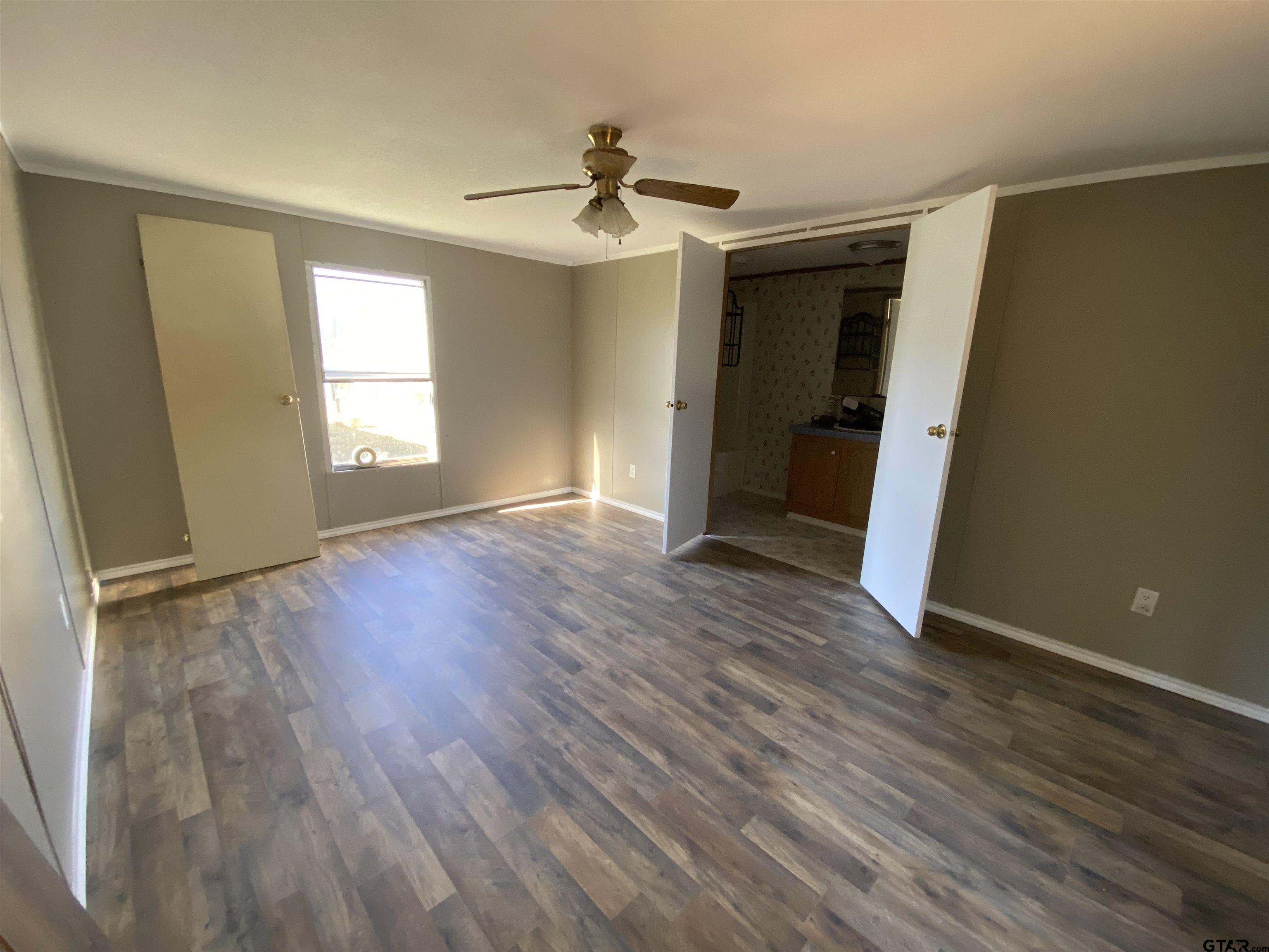 7761 Fm 1251 Henderson, TX 75652 - Photo 8 of 29 an empty room with wooden floor and windows