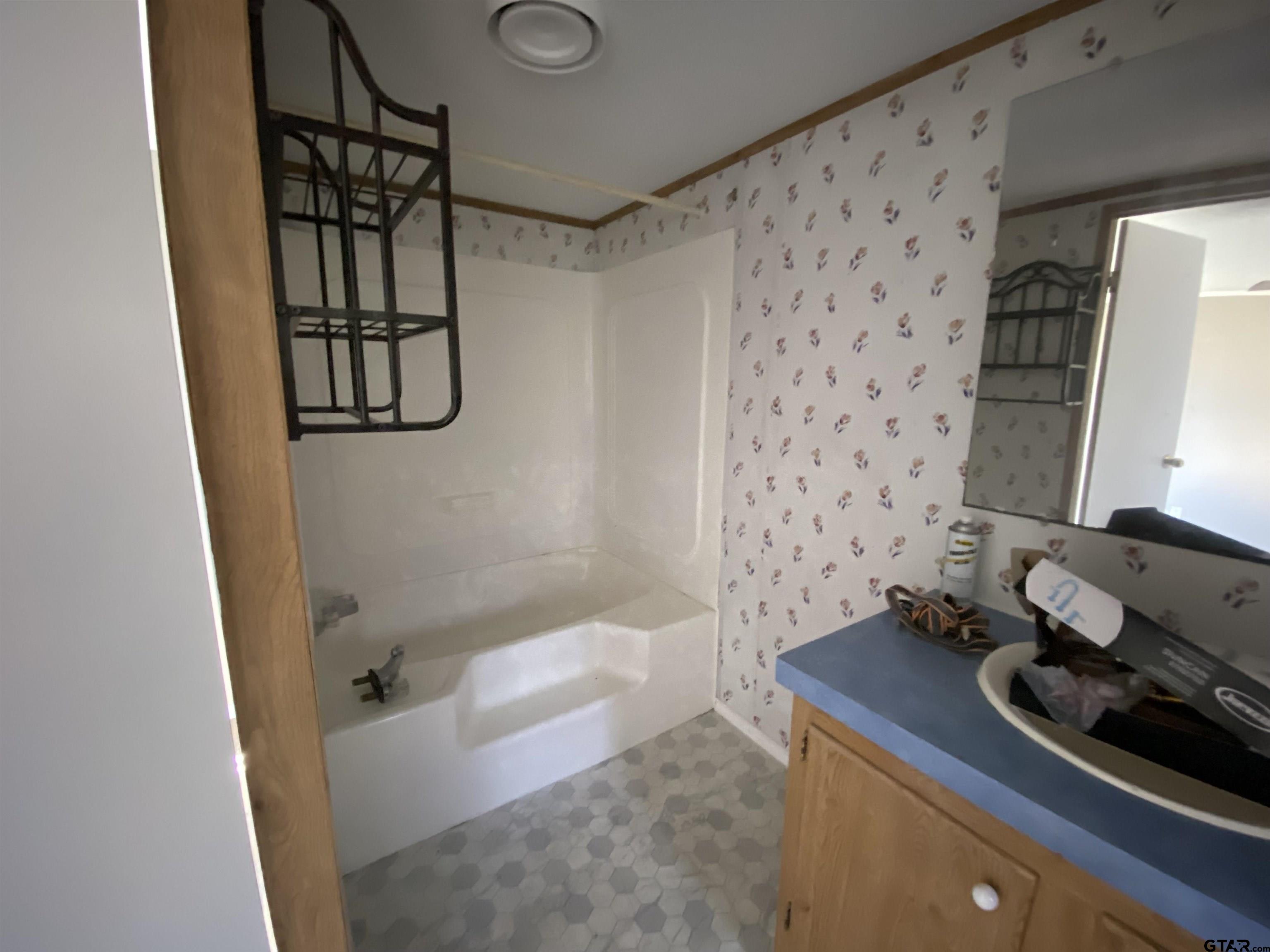 7761 Fm 1251 Henderson, TX 75652 - Photo 9 of 29 a bathroom with a bathtub and shower