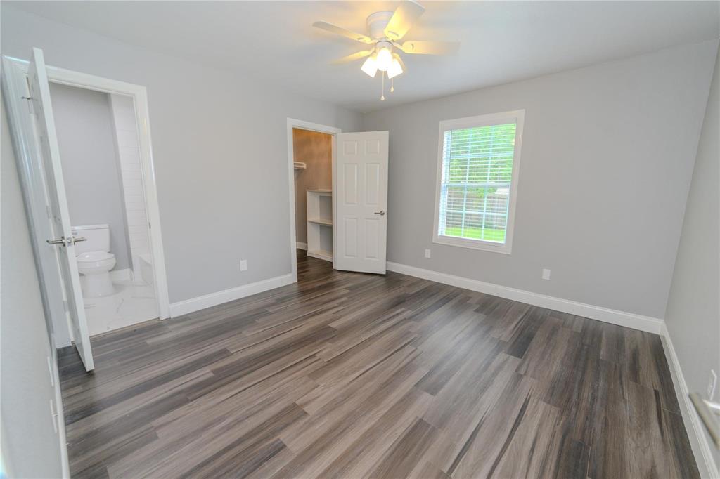 809 Wilcox Street McKinney, TX 75069 - Photo 12 of 26 Unfurnished bedroom featuring a spacious closet, a ceiling fan, and dark wood-type flooring