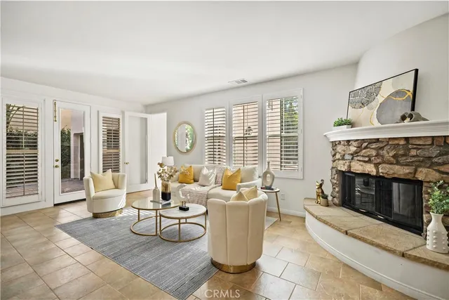 a living room with furniture large window and fireplace