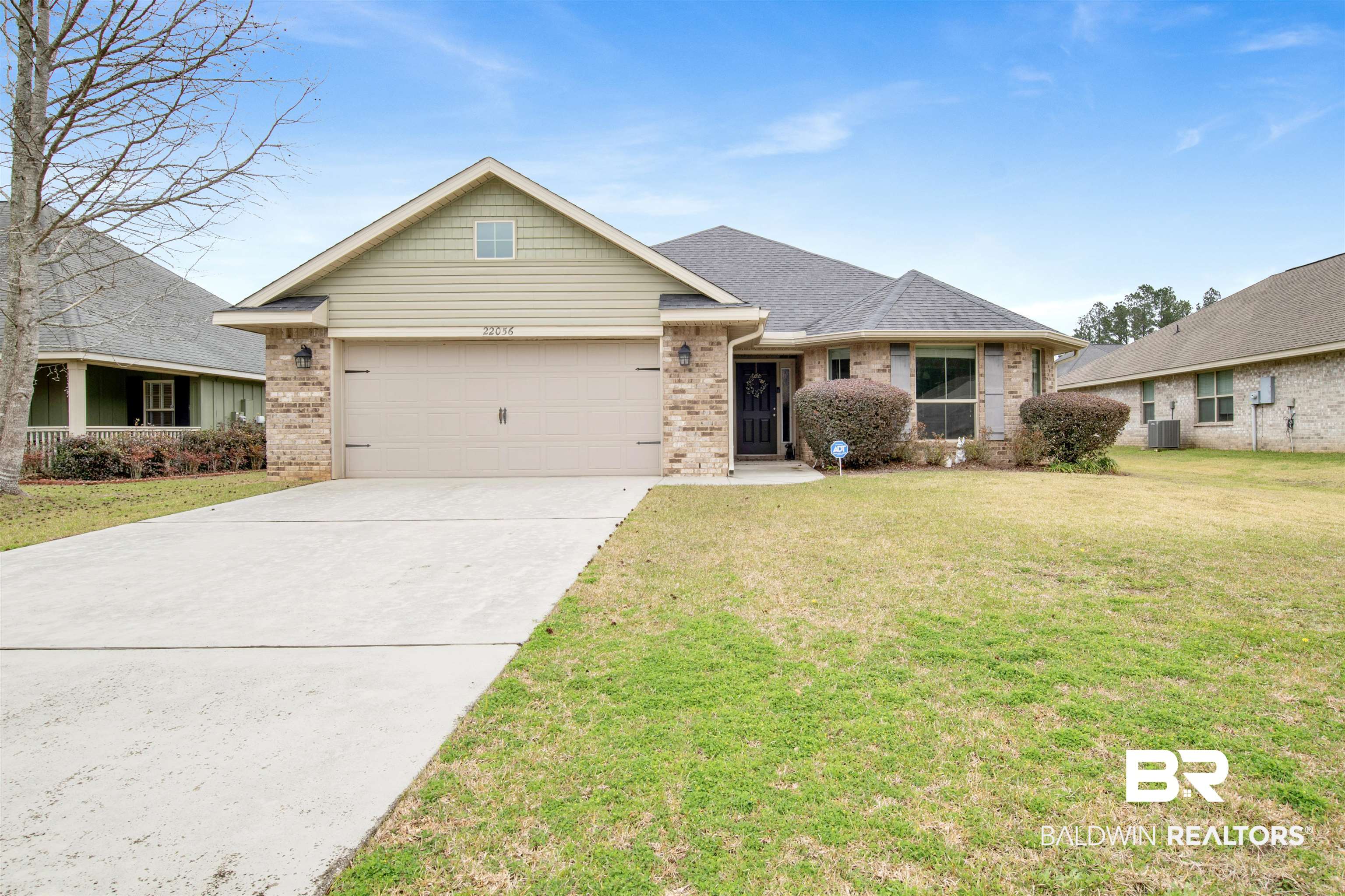 22056 Garland Loop Silverhill, AL 36576 - Photo 2 of 28 Single story home featuring roof with shingles, concrete driveway, an attached garage, brick siding, and a front lawn