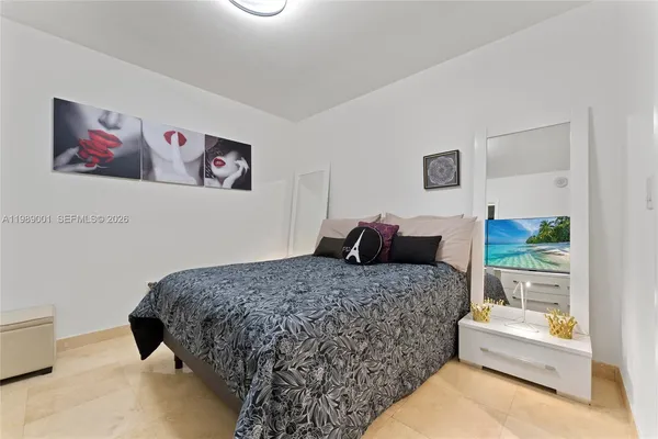 a bedroom with bed and glass door