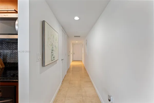 a view of hallway with wooden floor