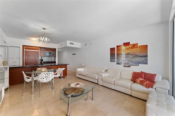 a living room with furniture and kitchen view