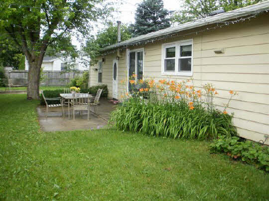 902 Lakeview Drive Rochelle, IL 61068 - Photo 10 of 10 a view of a backyard with table and chairs and a large tree