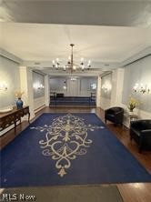 13800 Fairhill Road, Unit 416 Shaker Heights, OH 44120 - Photo 2 of 13 Lobby area featuring wood-finish flooring, a decorative area rug, and a central chandelier