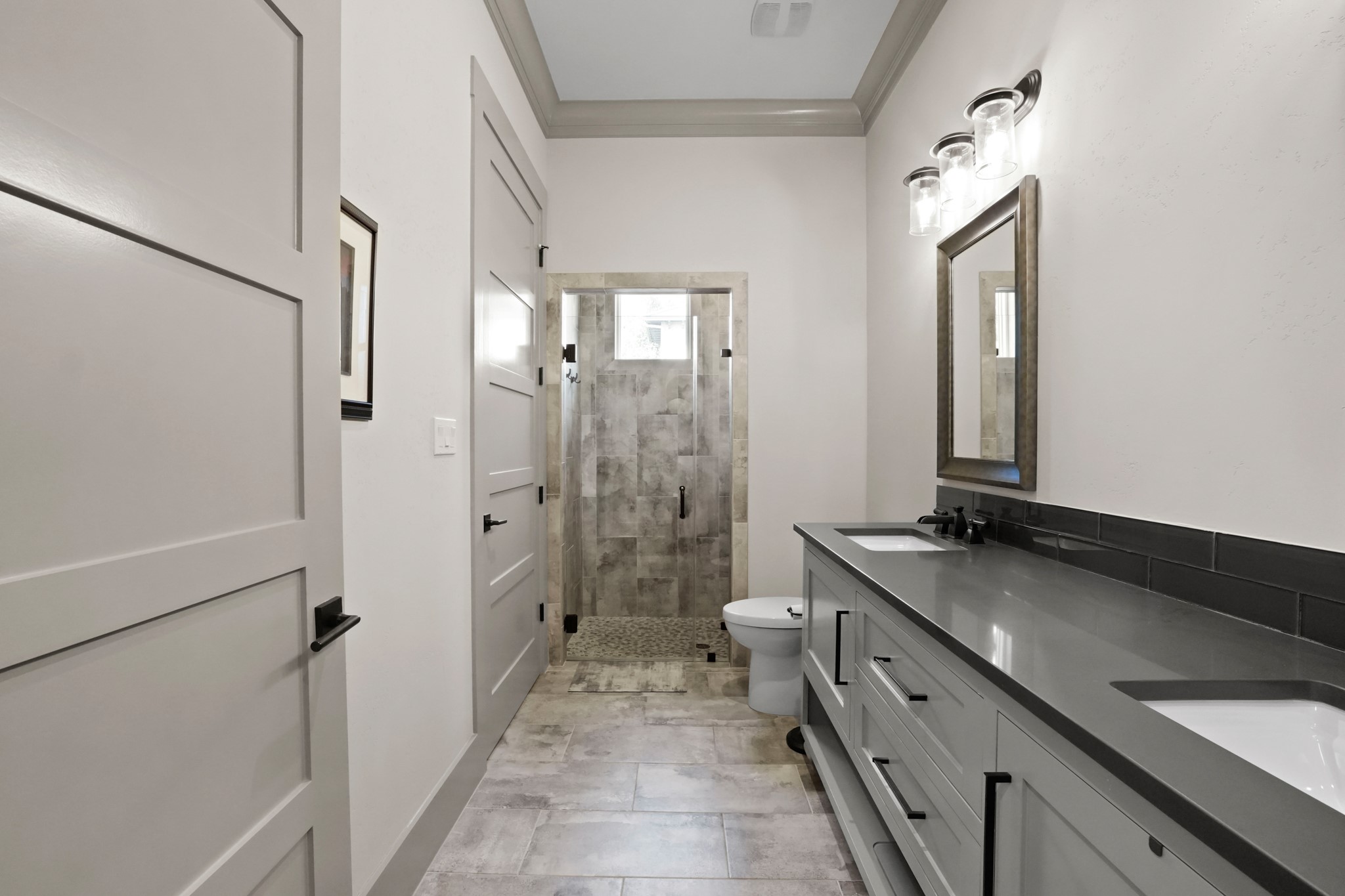 2753 Springwood Lane Georgetown, TX 78628 - Photo 29 of 40 a spacious bathroom with a granite countertop sink mirror and a shower