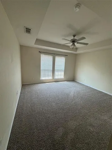 a view of a livingroom with a ceiling fan and window