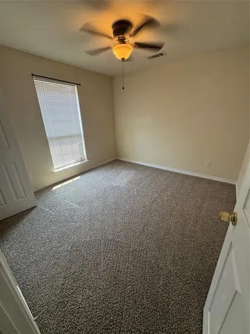 en empty room with windows and closet