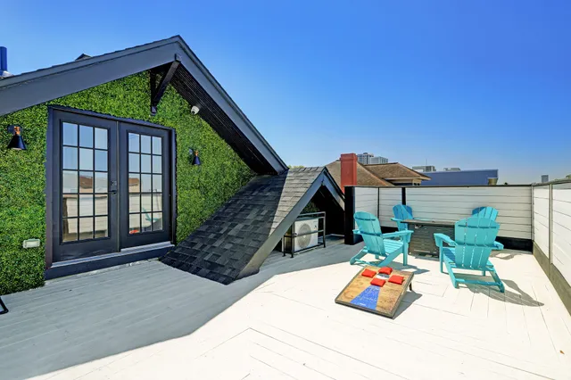 a backyard of a house with table and chairs