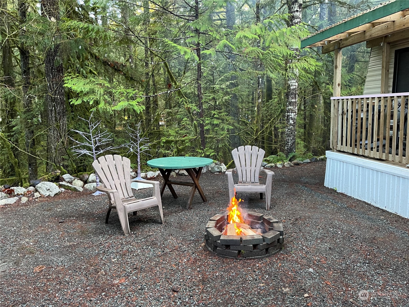 18 Drial Loop Maple Falls, WA 98266 - Photo 5 of 39 a view of a chair and fire pit in backyard of the house