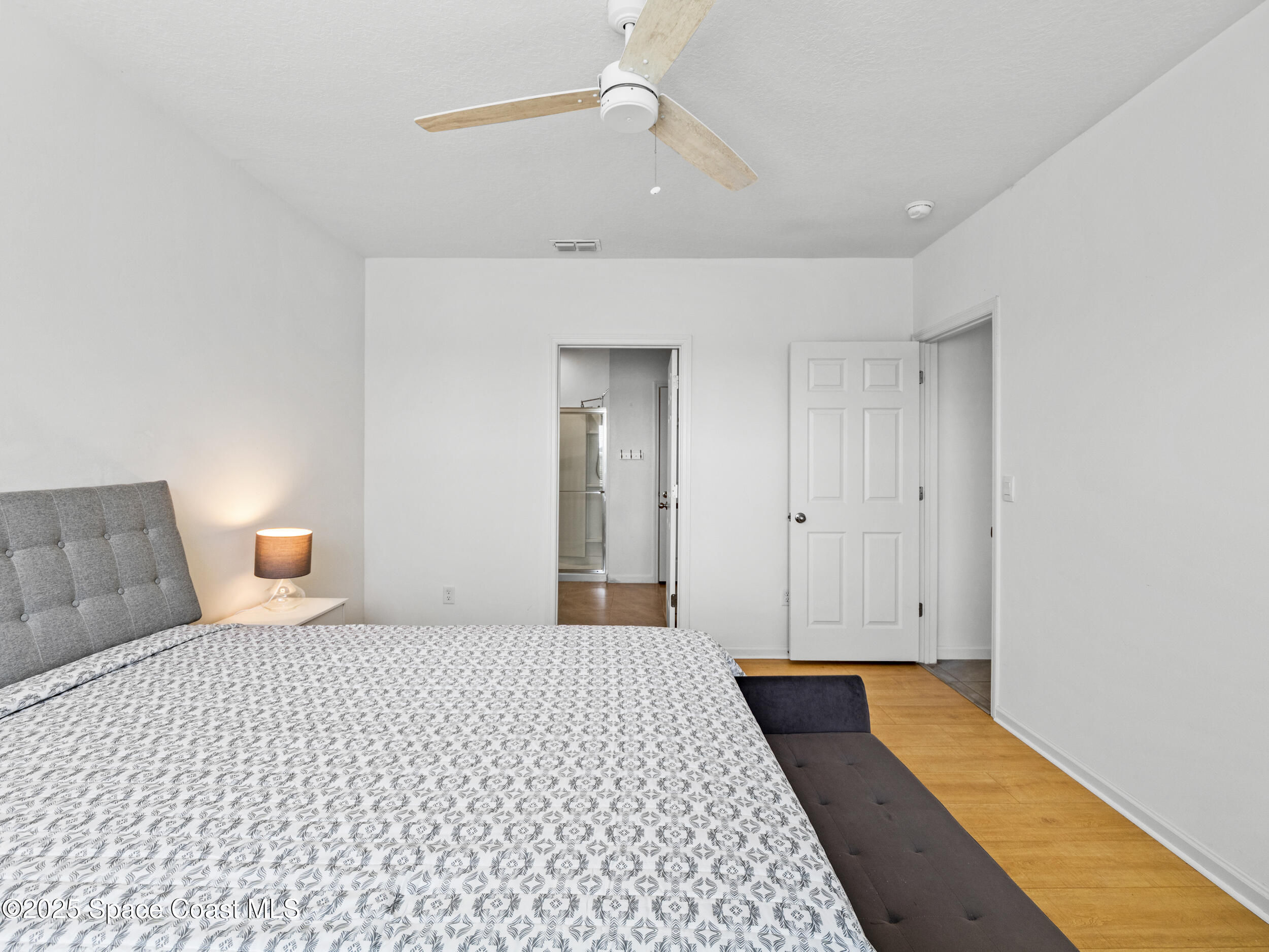 5678 Waterfall Place Grant, FL 32949 - Photo 17 of 25 a bedroom with a bed and a walk in closet