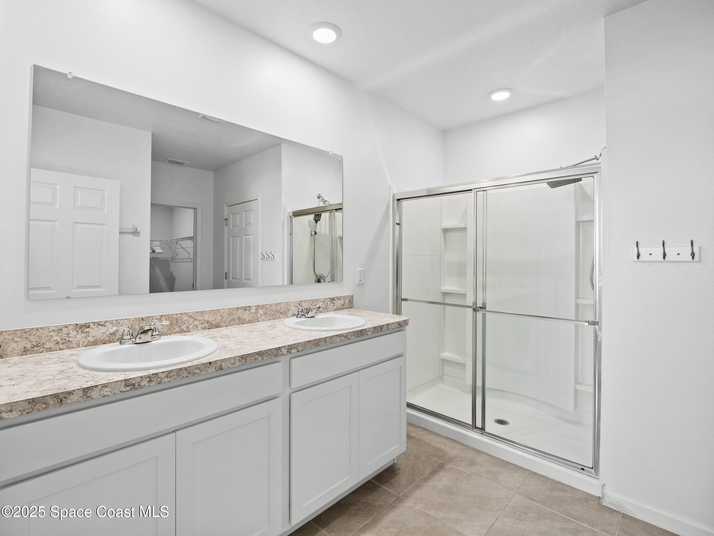 5678 Waterfall Place Grant, FL 32949 - Photo 18 of 25 a bathroom with a granite countertop sink mirror and a shower