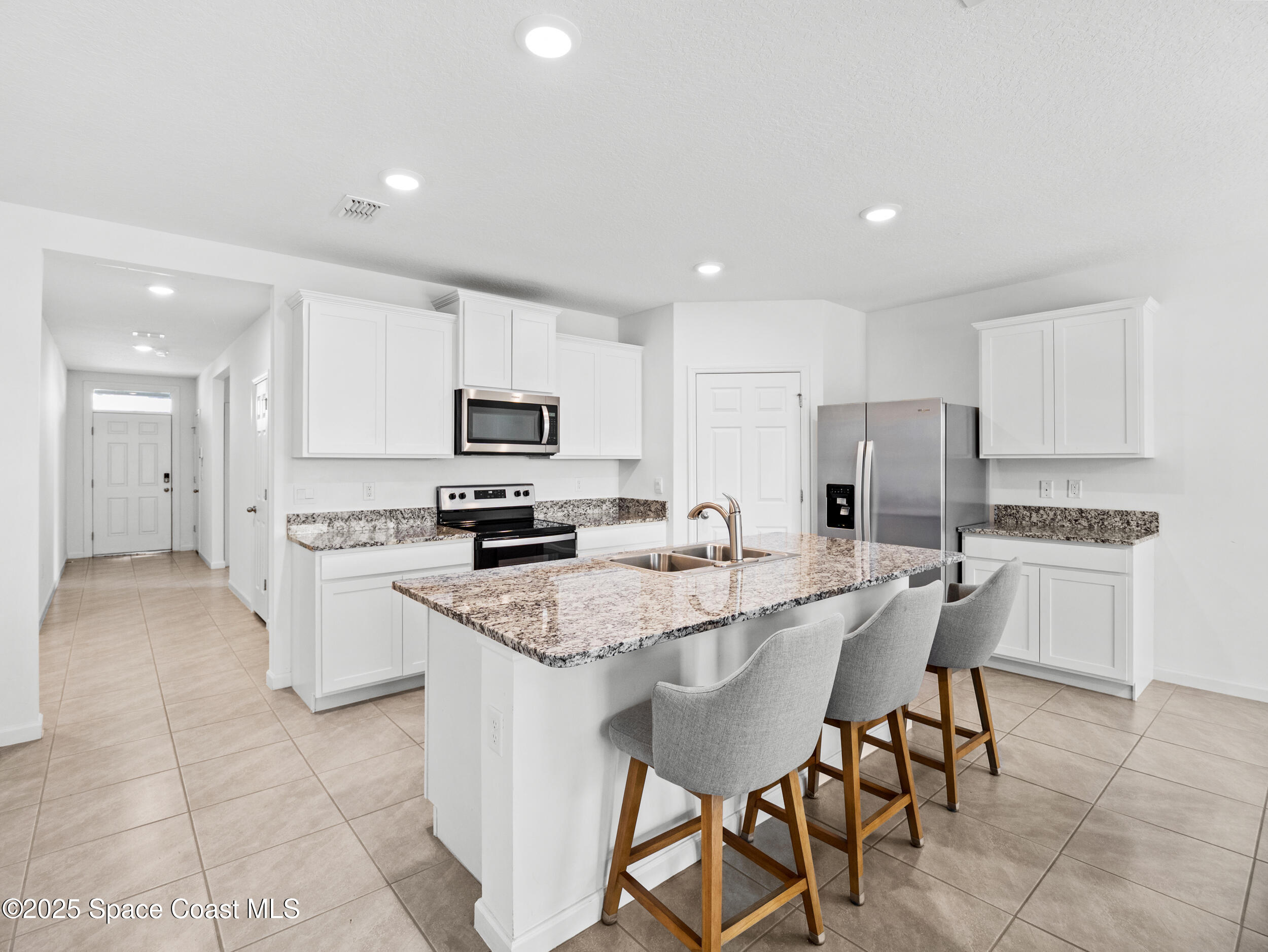 5678 Waterfall Place Grant, FL 32949 - Photo 4 of 25 a kitchen with appliances a sink and cabinets