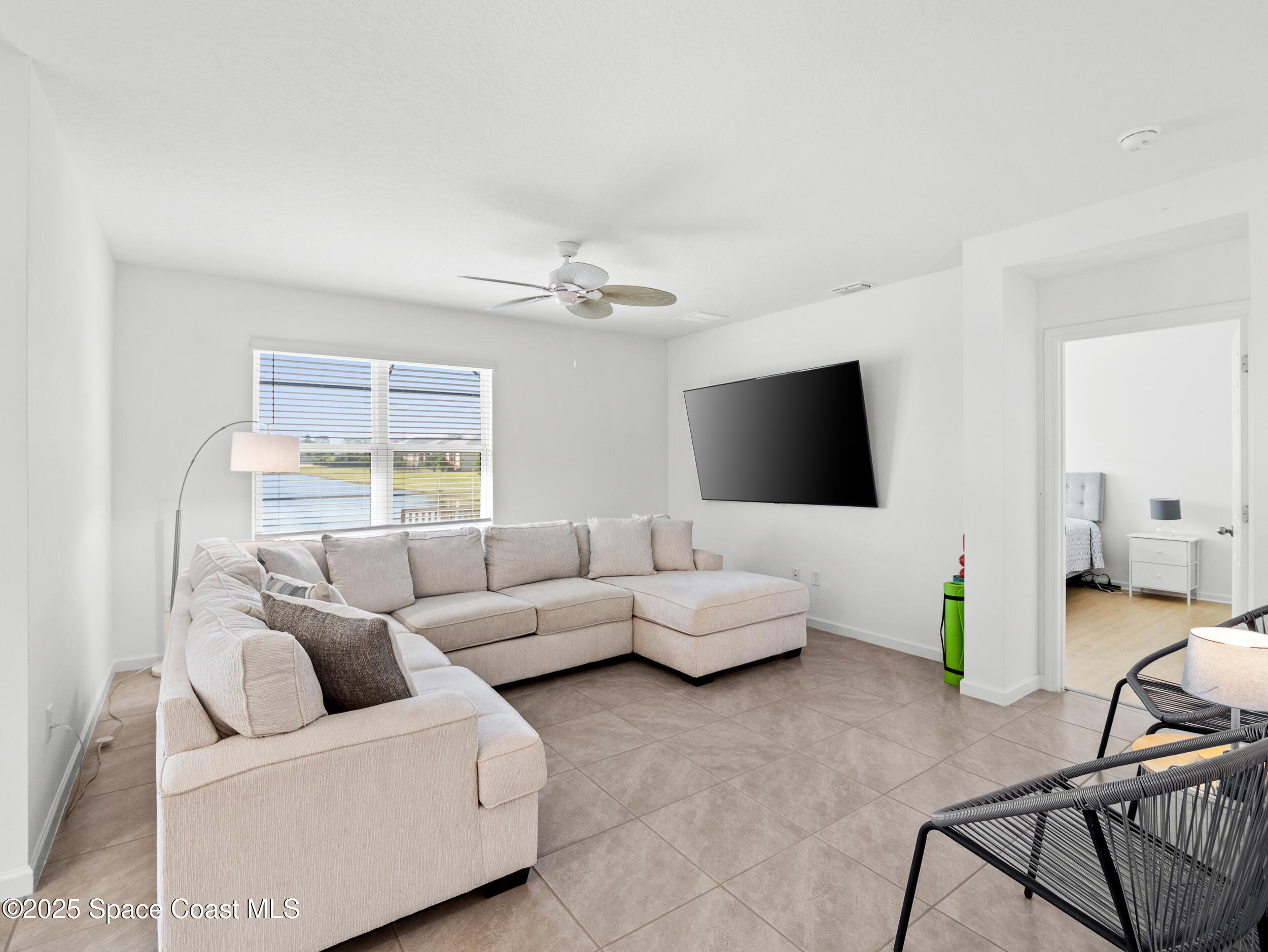 5678 Waterfall Place Grant, FL 32949 - Photo 9 of 25 a living room with furniture and a flat screen tv