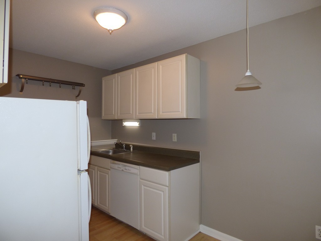 2 Leonard Road, Unit 2 Boxborough, MA 01719 - Photo 8 of 17 a kitchen with a refrigerator and cabinets