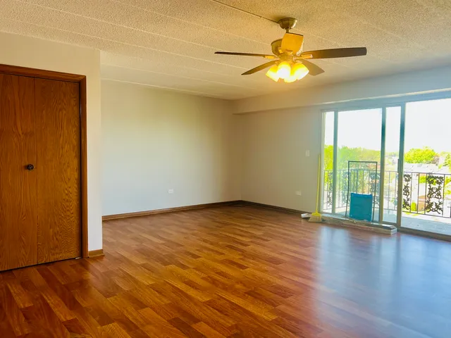 an empty room with wooden floor and a window