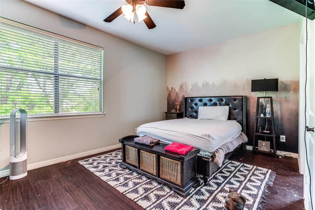 1912 Surrey Lane McKinney, TX 75072 - Photo 20 of 38 a bedroom with a bed and wooden floor