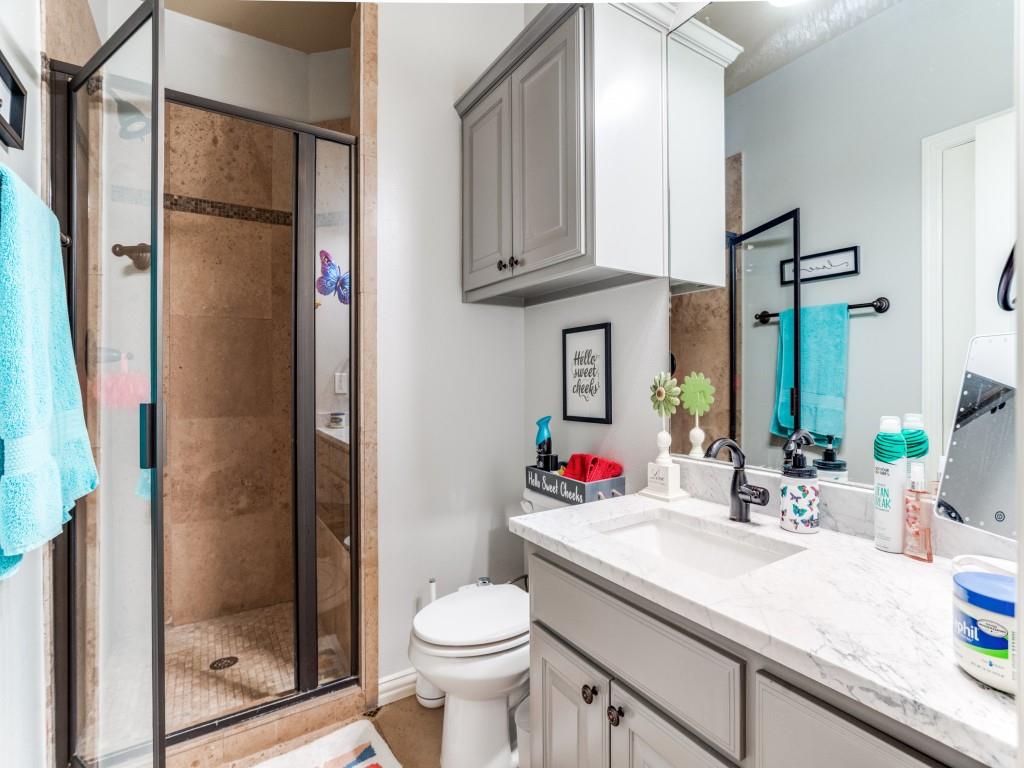 1912 Surrey Lane McKinney, TX 75072 - Photo 25 of 38 a bathroom with a granite countertop sink mirror vanity and toilet