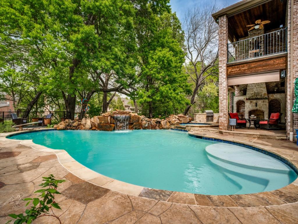 1912 Surrey Lane McKinney, TX 75072 - Photo 30 of 38 a view of a swimming pool with lawn chairs and plants