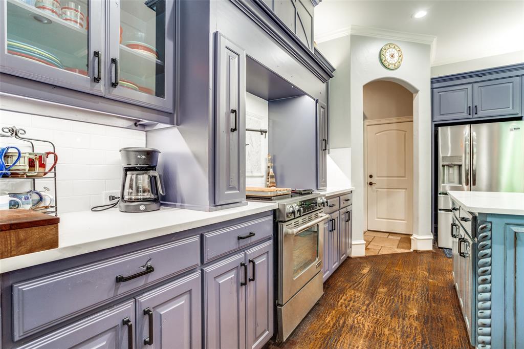 1912 Surrey Lane McKinney, TX 75072 - Photo 5 of 38 a large kitchen with stainless steel appliances granite countertop a stove and a sink with cabinets