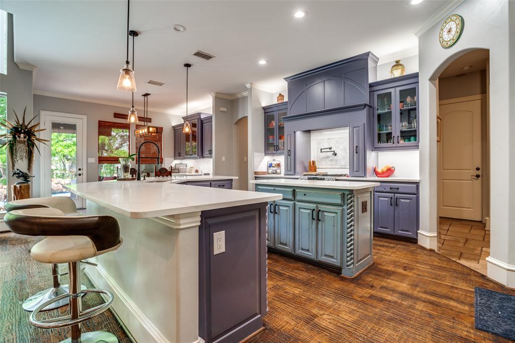 1912 Surrey Lane McKinney, TX 75072 - Photo 7 of 38 a kitchen with stainless steel appliances granite countertop a sink a stove and a refrigerator