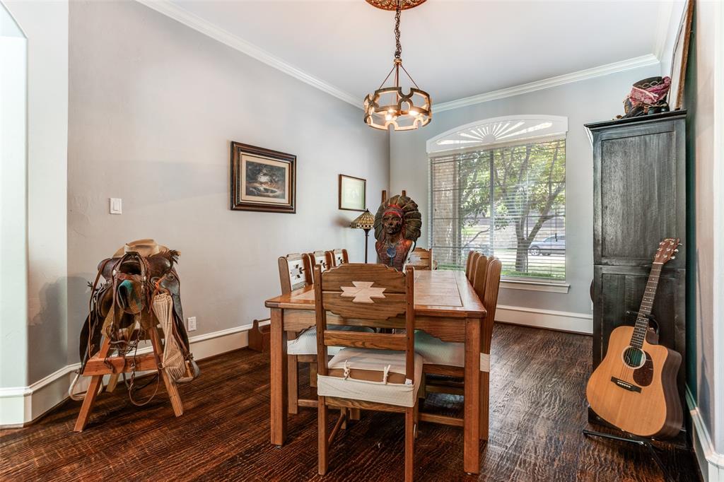 1912 Surrey Lane McKinney, TX 75072 - Photo 9 of 38 a view of a dining room with furniture window and wooden floor
