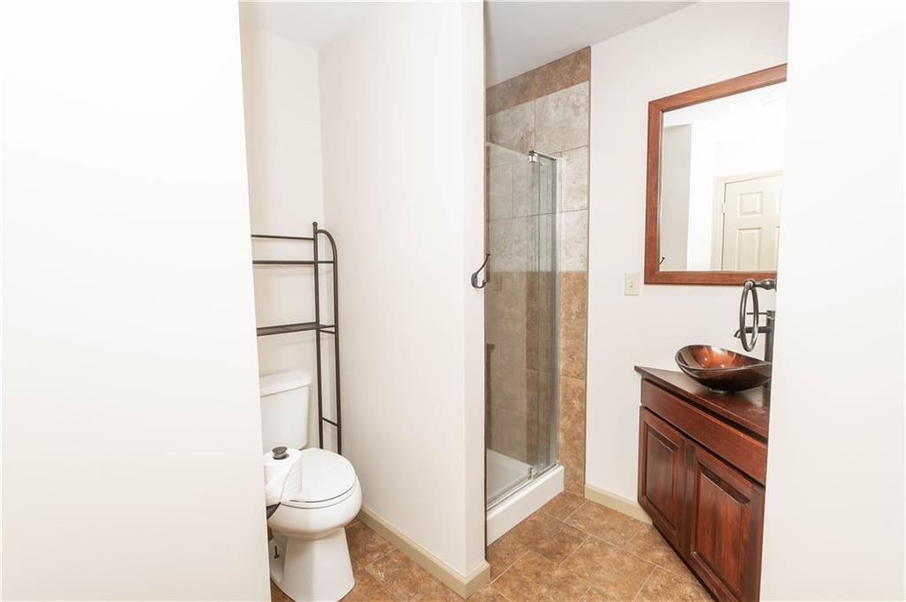 153 McMillen Road Home, PA 15747 - Photo 12 of 25 a bathroom with a granite countertop sink toilet and shower