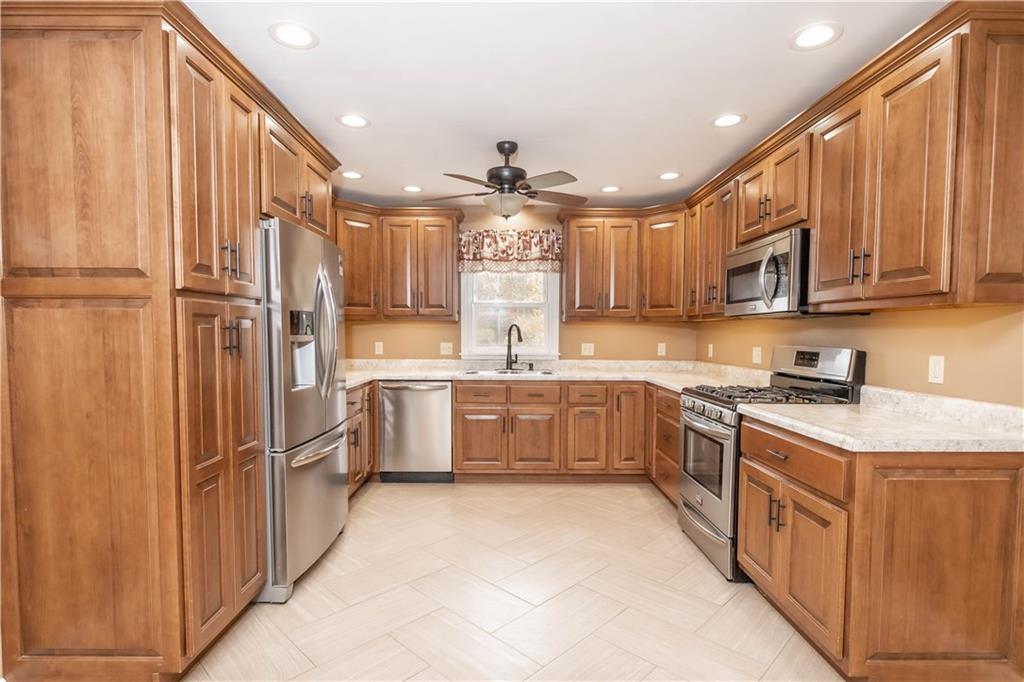 153 McMillen Road Home, PA 15747 - Photo 4 of 25 a kitchen with stainless steel appliances granite countertop a sink a stove a refrigerator cabinets and a kitchen island