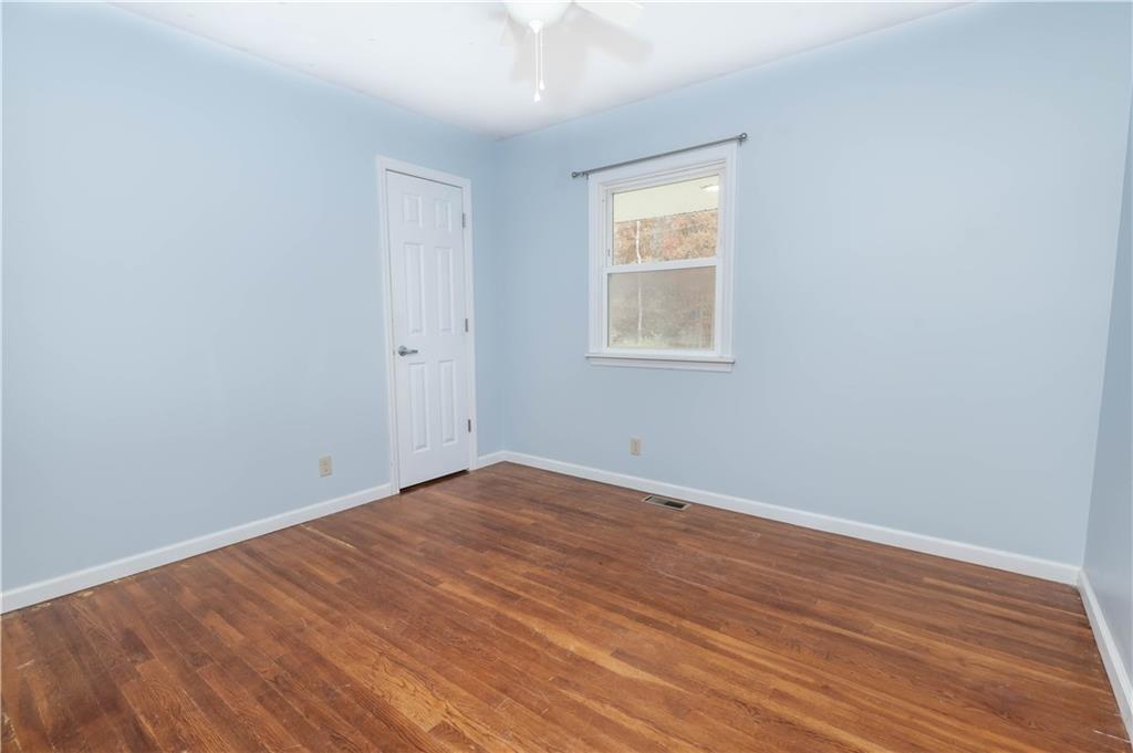 153 McMillen Road Home, PA 15747 - Photo 10 of 25 an empty room with wooden floor and windows