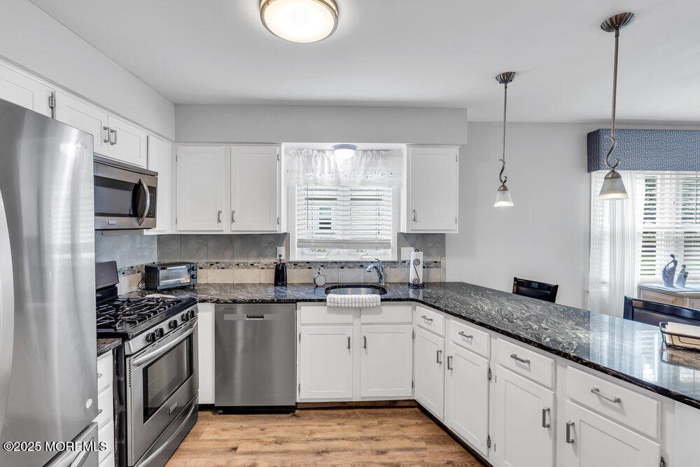 16 Thames Place Brick, NJ 08723 - Photo 12 of 28 a kitchen with granite countertop white cabinets white stainless steel appliances a sink and a window