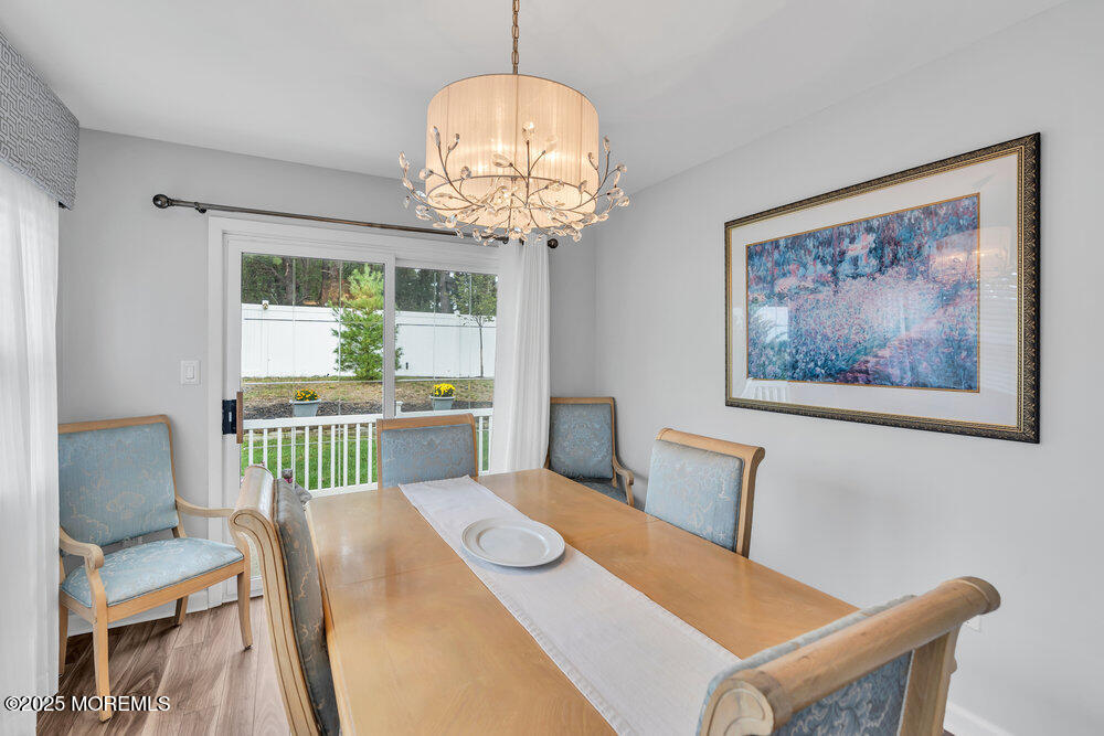 16 Thames Place Brick, NJ 08723 - Photo 14 of 28 a view of a dining room with furniture a chandelier and wooden floor