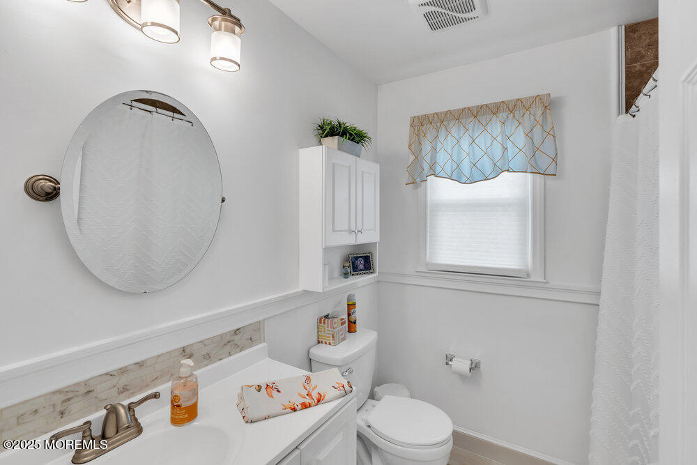 16 Thames Place Brick, NJ 08723 - Photo 15 of 28 a bathroom with a sink a toilet and a mirror
