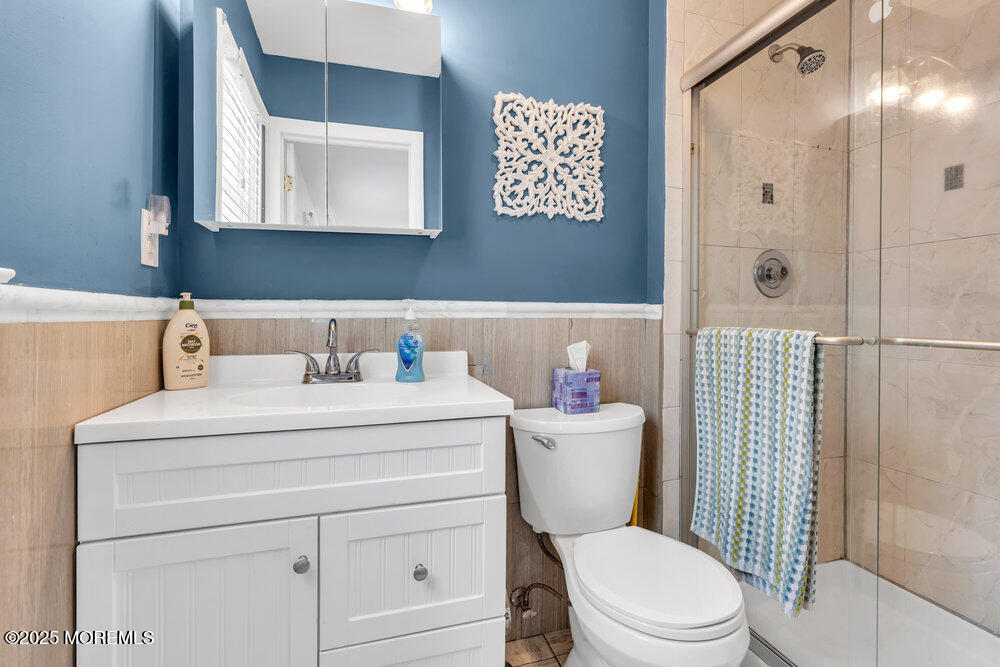 16 Thames Place Brick, NJ 08723 - Photo 23 of 28 a bathroom with a toilet sink vanity and mirror