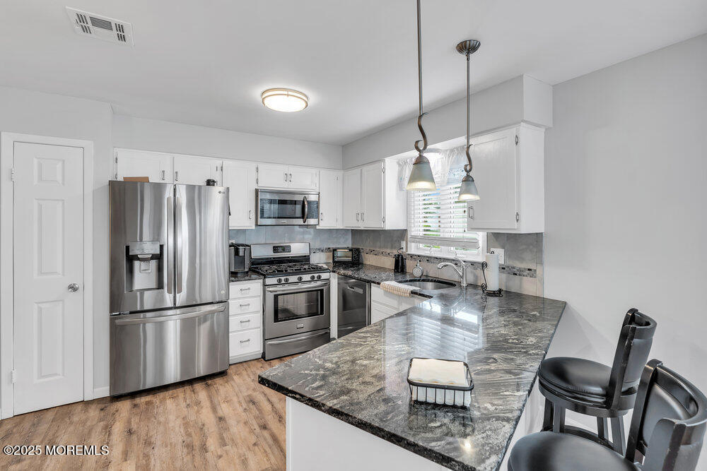 16 Thames Place Brick, NJ 08723 - Photo 8 of 28 a kitchen with stainless steel appliances granite countertop a sink refrigerator and cabinets