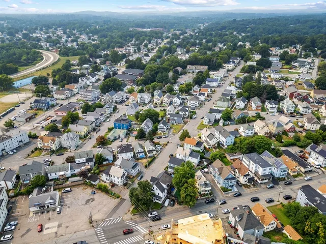 an aerial view of residential houses with city view