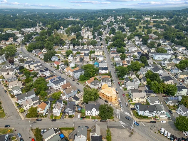 an aerial view of residential houses with city view