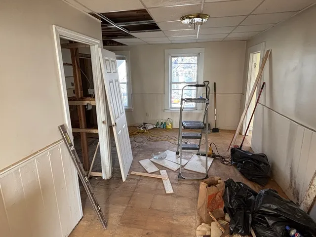 a living room with lots of furniture and a wooden floor