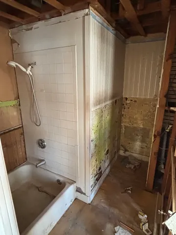 a view of a bedroom with two beds and a window