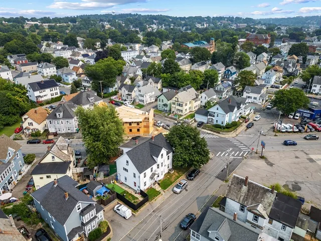 an aerial view of residential houses with outdoor space