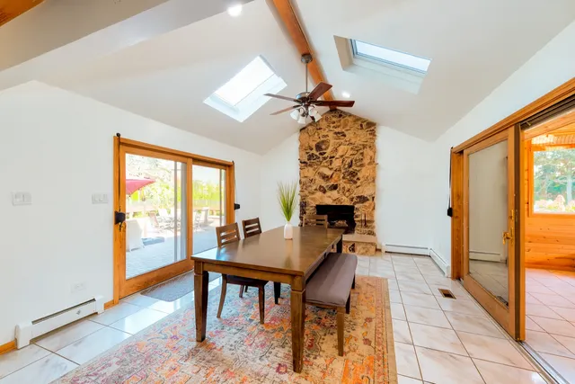 a view of a dining room with furniture and a window