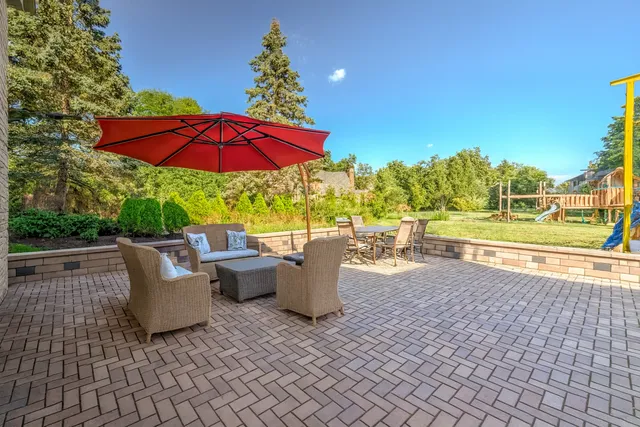 an outdoor space with furniture and umbrella
